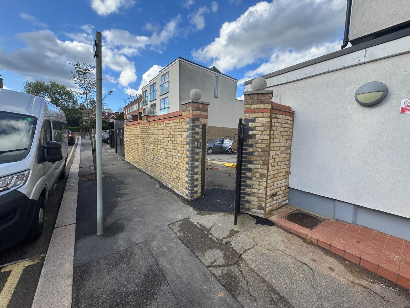 Exterior wall construction with finished render and brick detailing